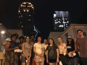 students in front of night skyline