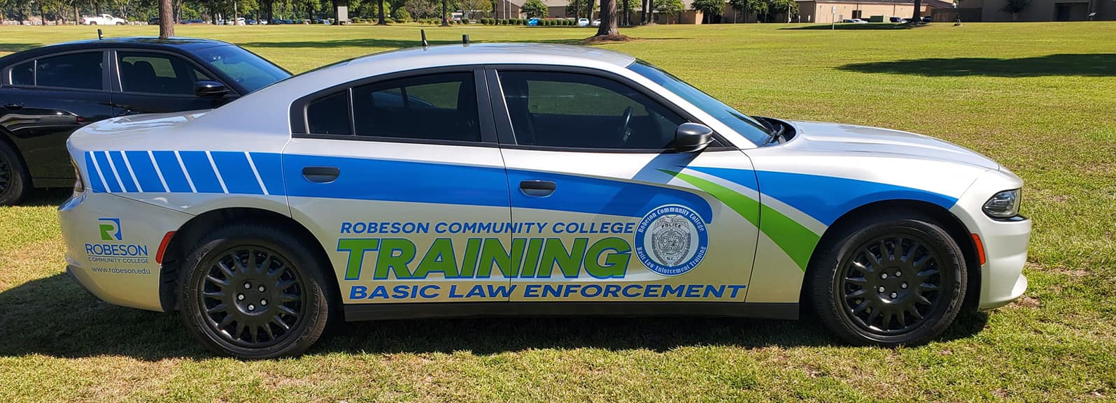 BLET cars in front of RCC sign