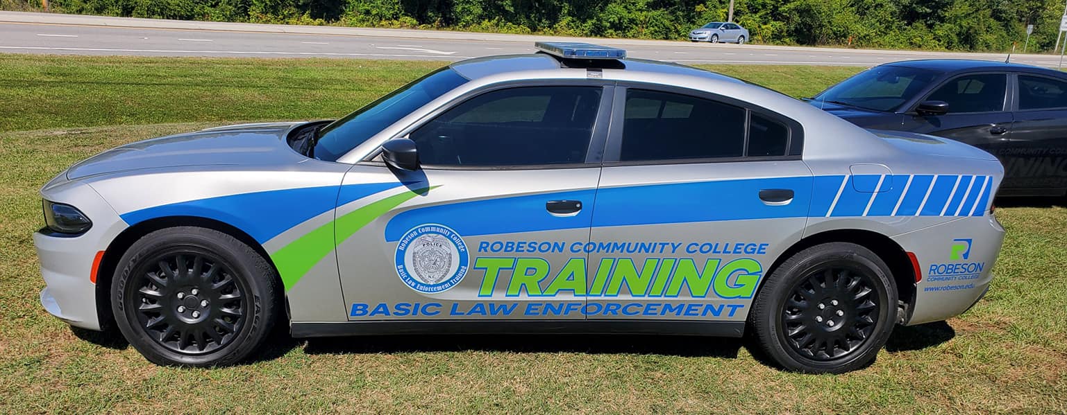 BLET cars in front of RCC sign