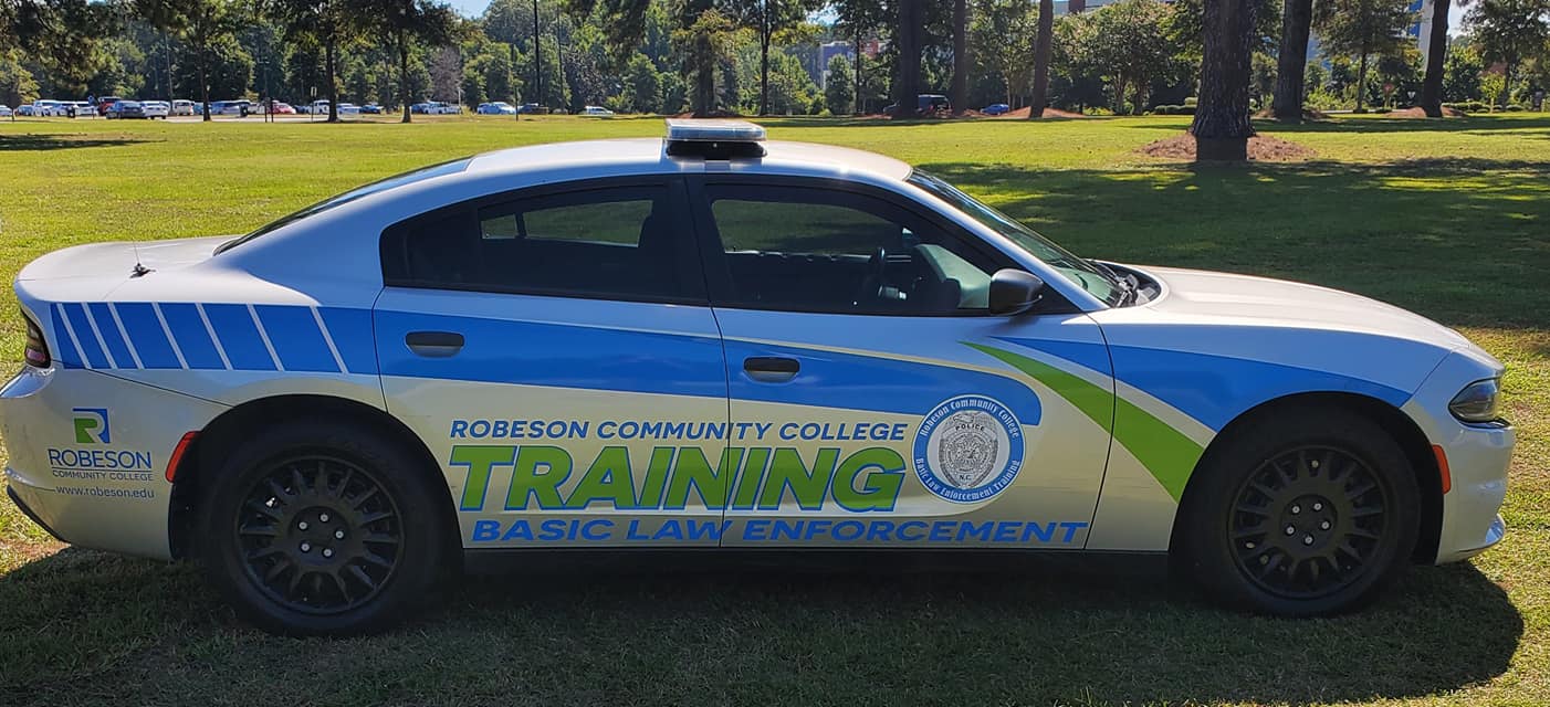 BLET cars in front of RCC sign