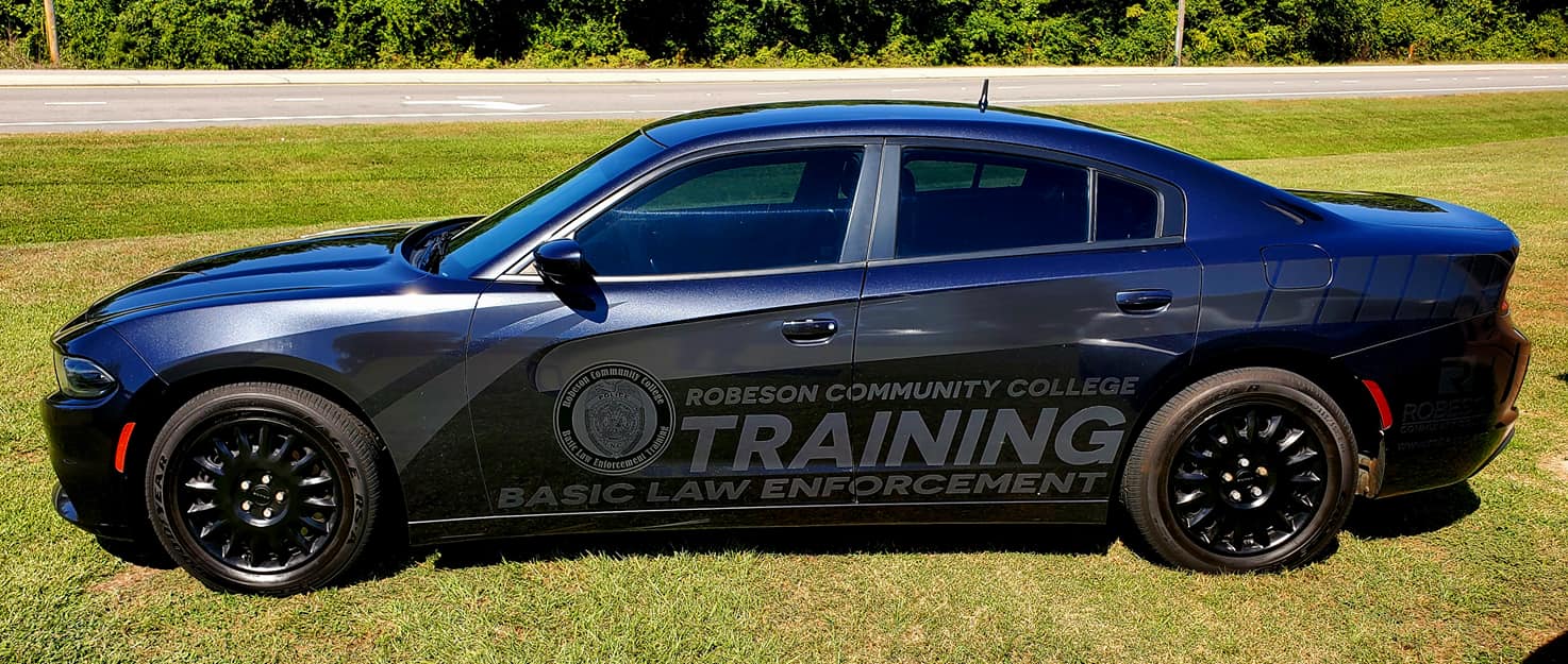 BLET cars in front of RCC sign