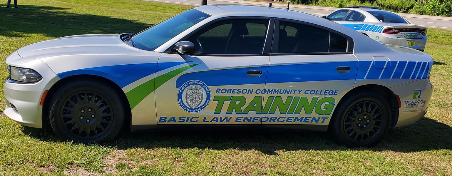 BLET cars in front of RCC sign