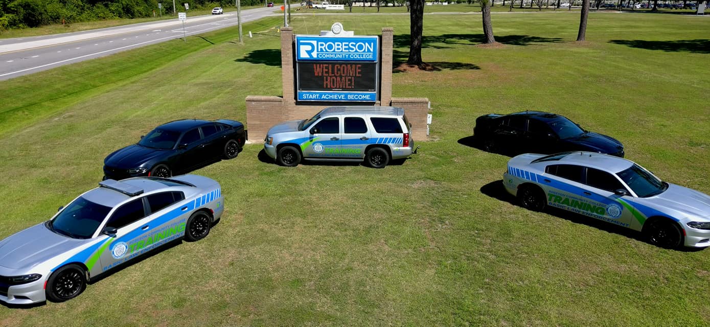BLET cars in front of RCC sign