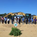 people with shovels breaking ground for the new building