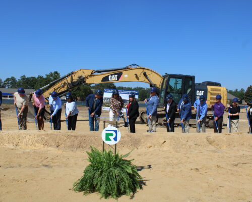 people with shovels breaking ground for the new building