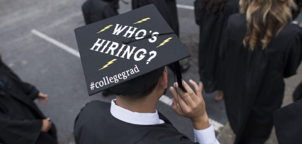 Career Services college graduate with who's hiring on his graduation cap