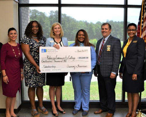 Dr. Gold accepting check from Piedmont and Matrix Services
