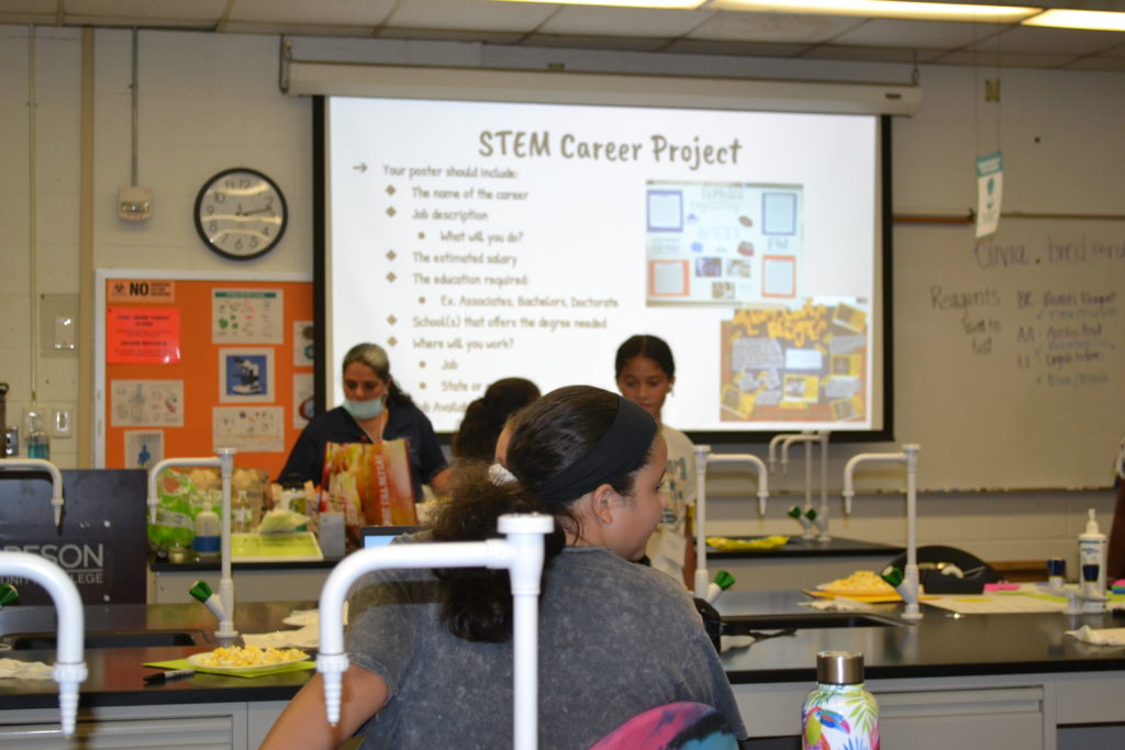 STEM camp forensics student with poster