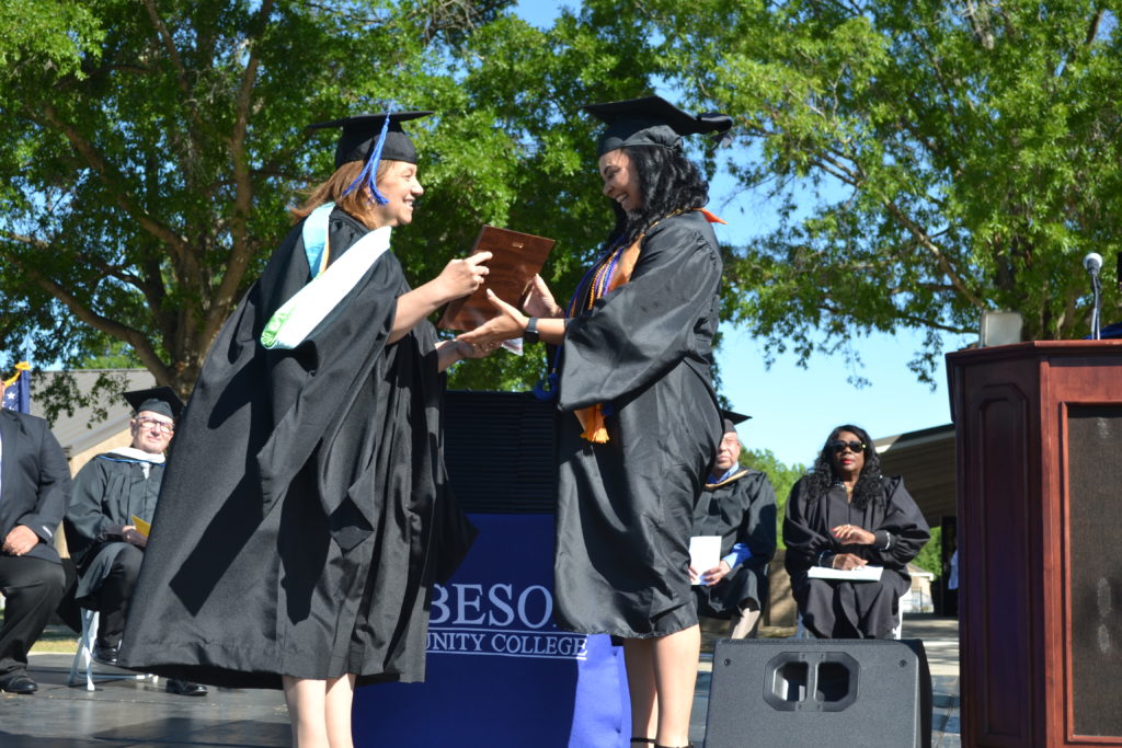 Krystal Clark receives degree from President at Graduation 2022 ceremony