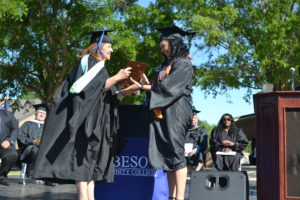Krystal Clark receives degree from President at Graduation 2022 ceremony