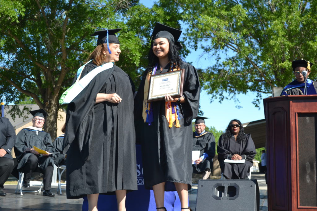 Krystal Clark receives degree from President at Graduation 2022 ceremony