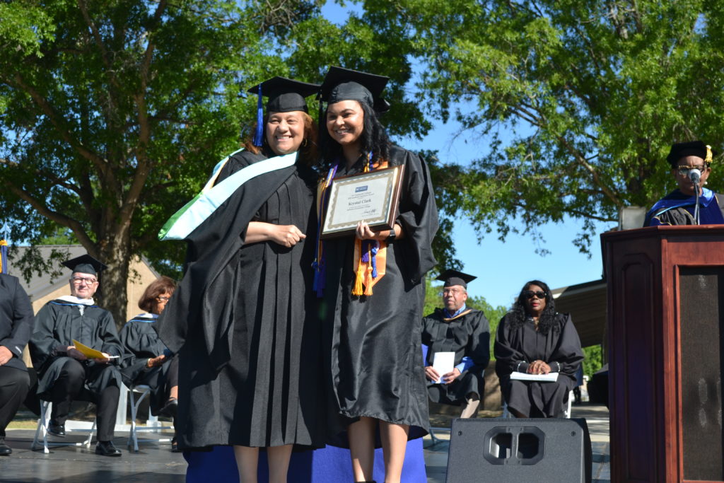 Krystal Clark receives degree from President at Graduation 2022 ceremony
