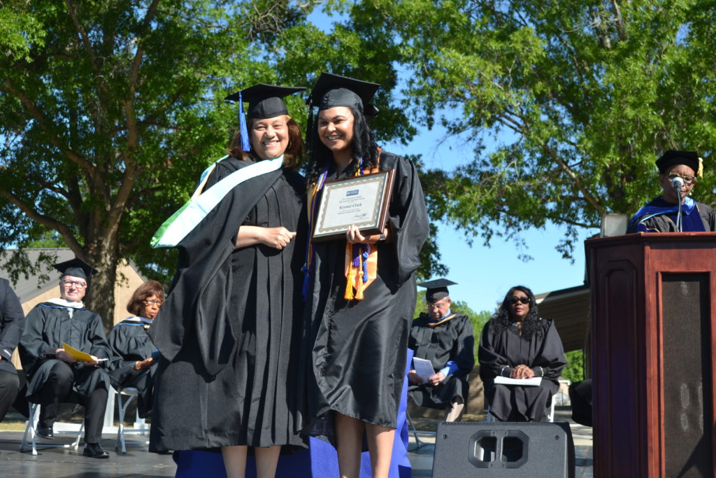 Krystal Clark receives degree from President at Graduation 2022 ceremony