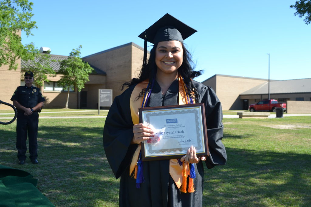 Krystal Clark receives degree from President at Graduation 2022 ceremony