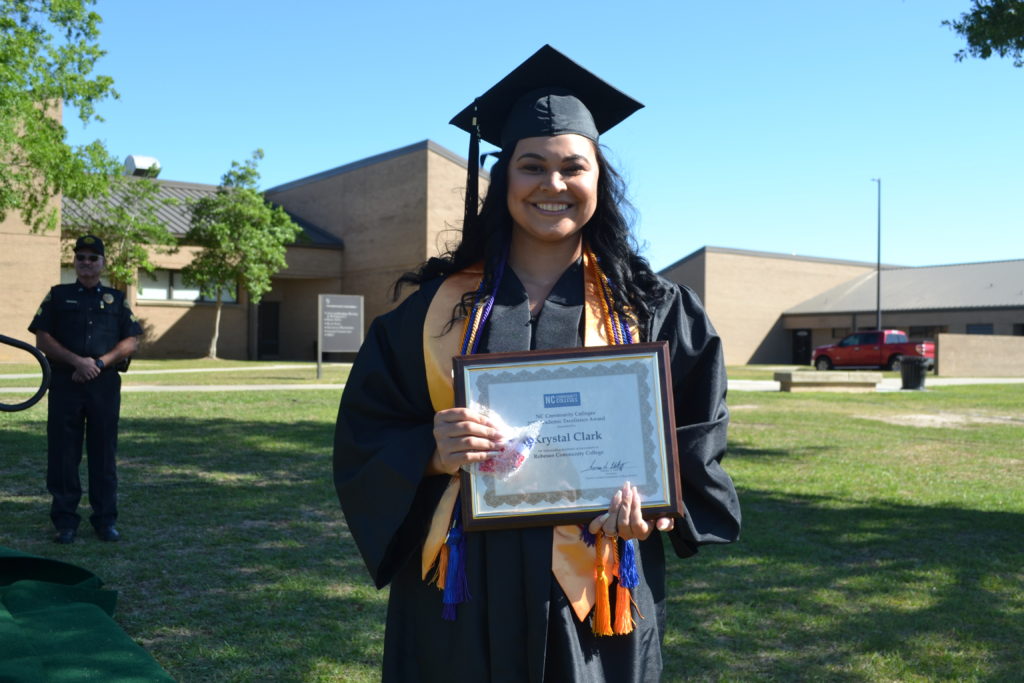 Krystal Clark receives degree from President at Graduation 2022 ceremony