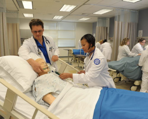 Two individuals in Nursing Room giving aid to