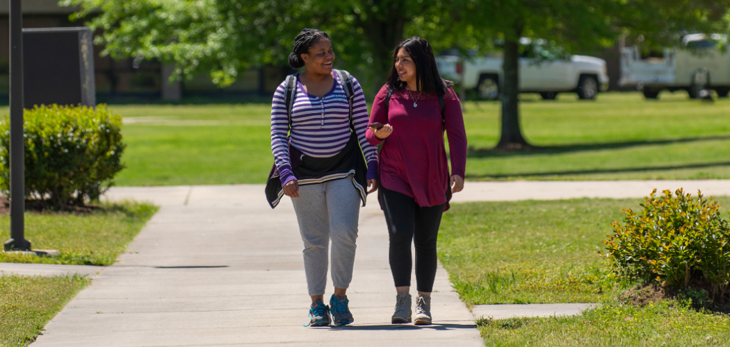 Two students walking on campus