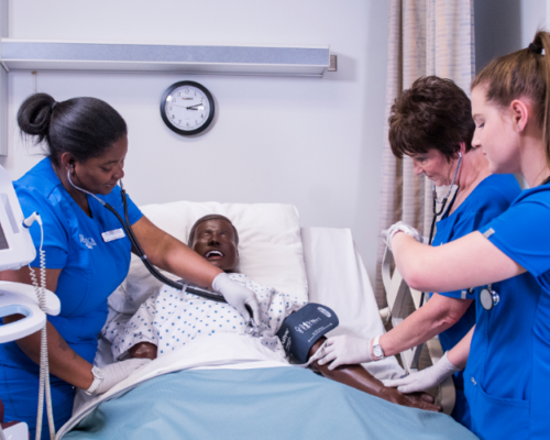 Students performing nursing procedures