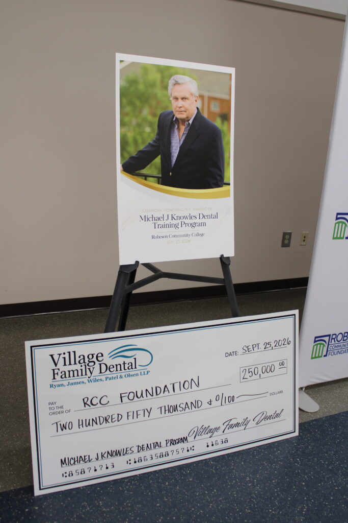 Dr. Michael J. Knowles - check donation for the Michael J. Knowles Dental Training Program