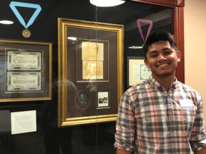 Student standing in front of UNC Chapel Hill display