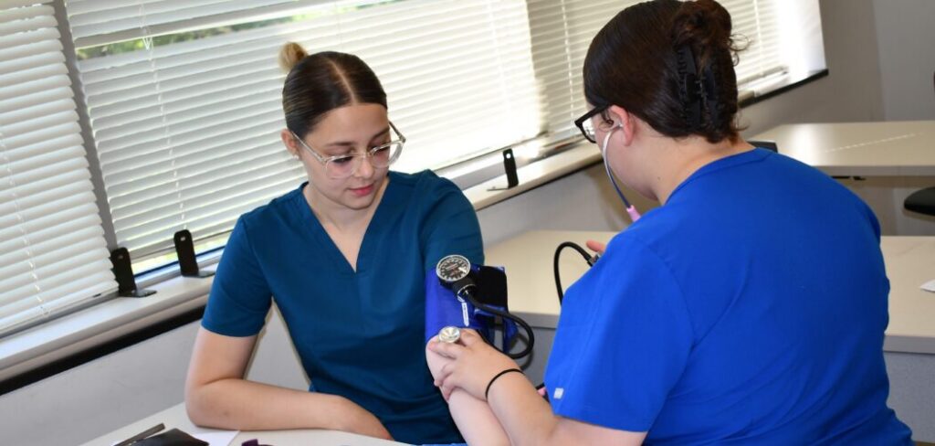 Nurse Aide student checking blood pressure