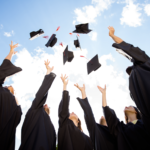 Graduates throwing caps into the air