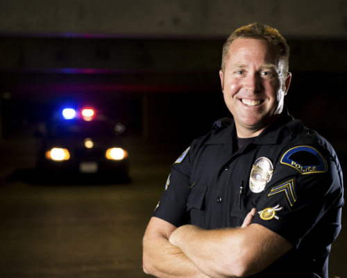 cop standing in front of cop car