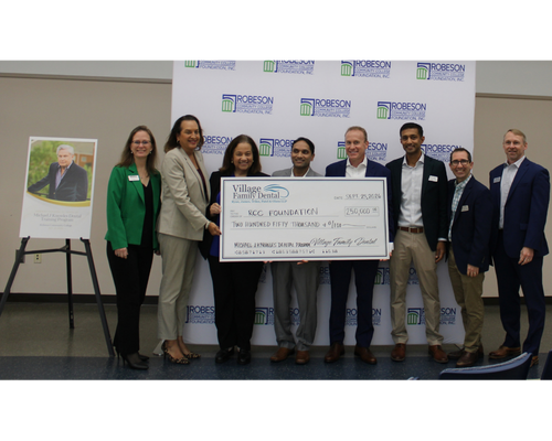 check presentation from Village Family Dental to the RCC foundation