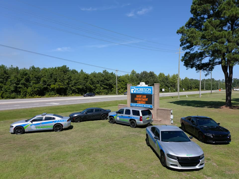 BLET cars in front of RCC sign