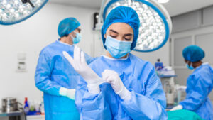 hospital employee putting on glove